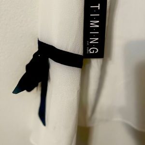 Elegant White Top With Black Accents